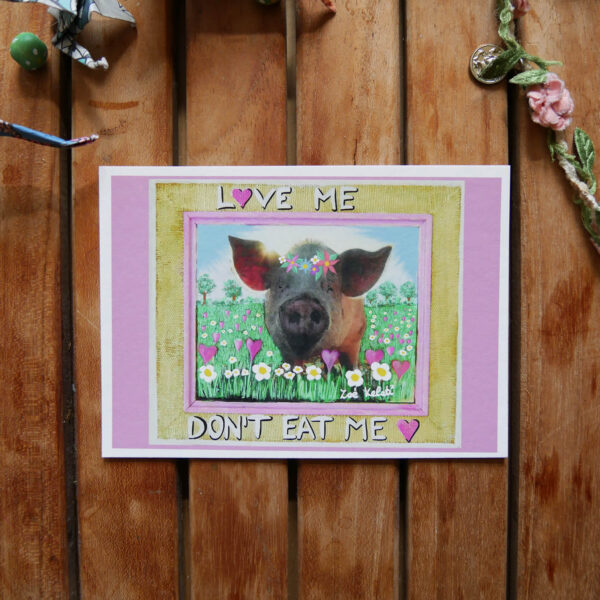bamboo postcard with a little pig with flowercrown and the text love me don't eat me written on it vegan